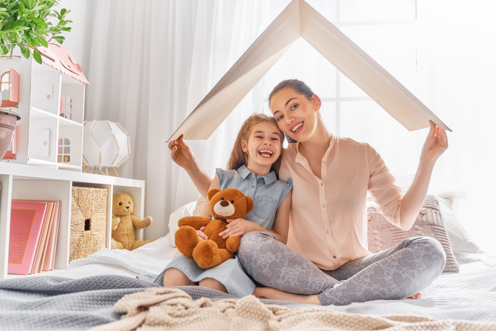 mom and daughter under a sheet tent