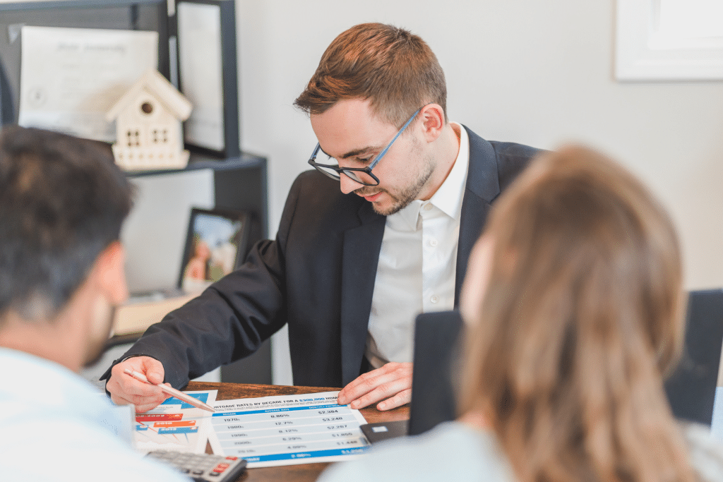 man showing a couple real estate data