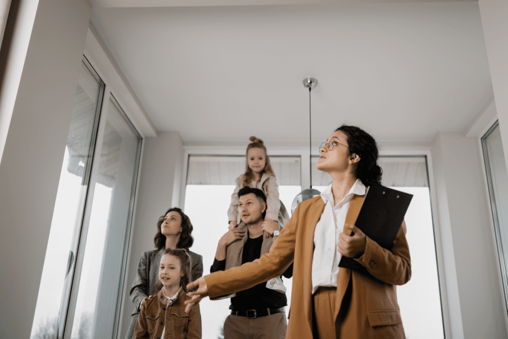 real estate agent showing a family of four people a rental property