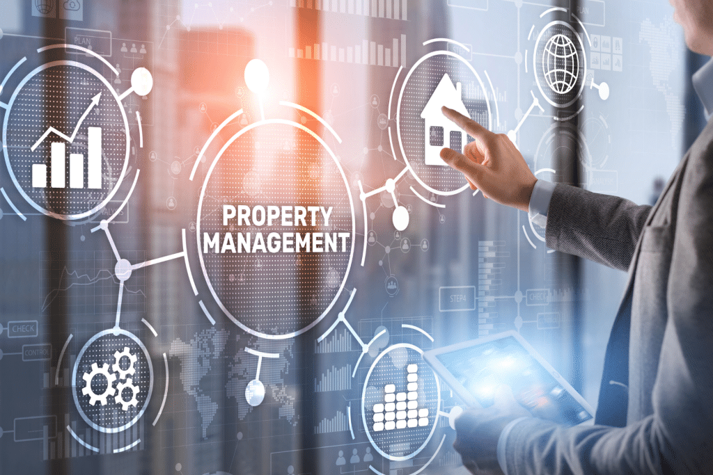 A man's hand pointing at a glass window that has a digital overlay of the words "property management", a house icon, a bar graph, and gear icons on it.
